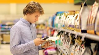 Young man shopping for dog food