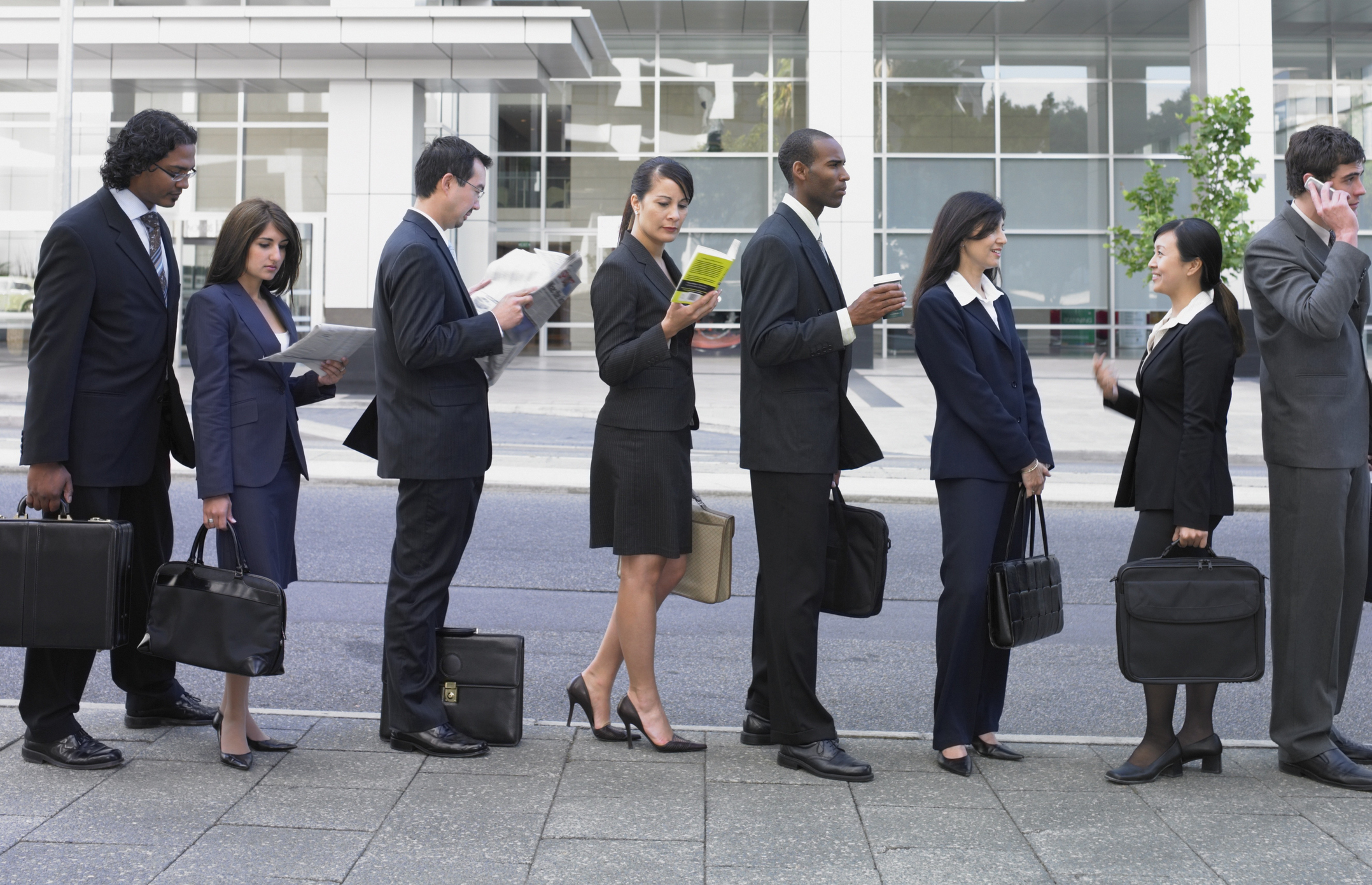 A line of business people or prospective financial advisers waiting outside.