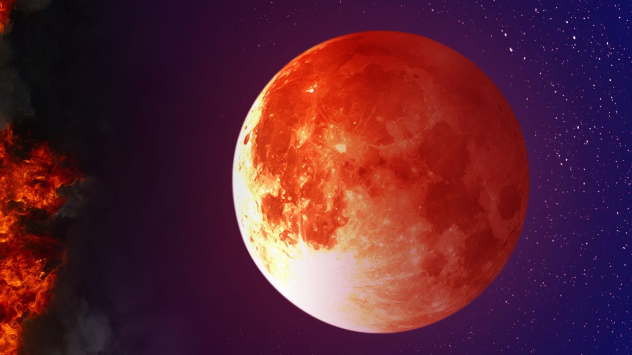 Hunter&#039;s Moon: Landscape of night sky with super blood moon above the fire. - stock photo.