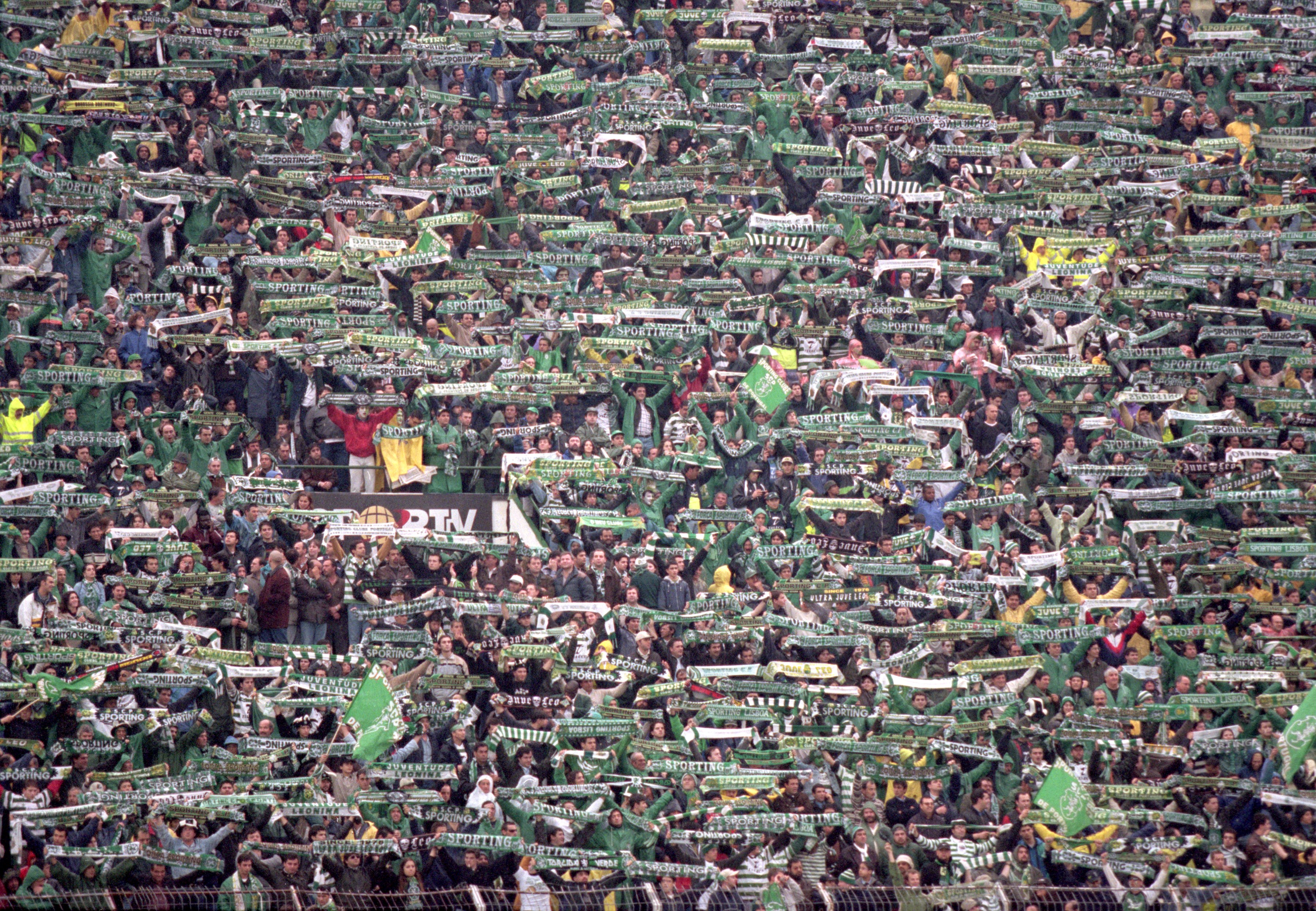 Sporting CP fans hold up scarves ahead of a game against Lisbon rivals Benfica in May 2000.