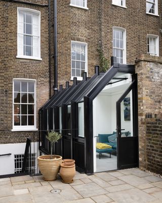black steel and glass extension to brick terrace house