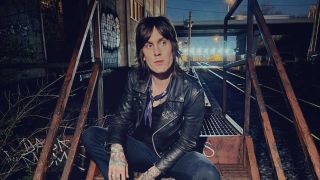 Tuk Smith sitting on some stairs
