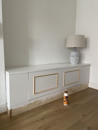 A TV stand in the process of adding molding detail