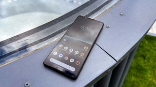 The Sony Xperia 1 V from the front on a metal surface