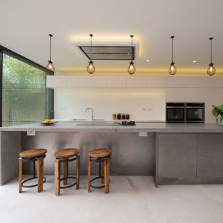 kitchen with grey kitchen counter and wood and iron stool