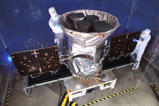 Technicians work on NASA’s Transiting Exoplanet Survey Satellite, which is scheduled to launch on April 16, 2018.