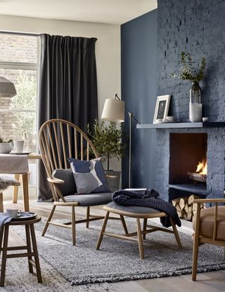 Dark blue living room by John Lewis with Windsor style armchair and footstool.