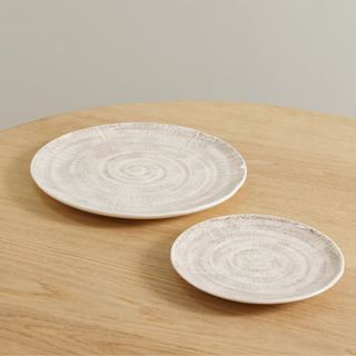 Two white dinner plates with rustic designs