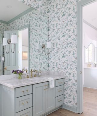 light blue bathroom with white and blue floral wallpaper