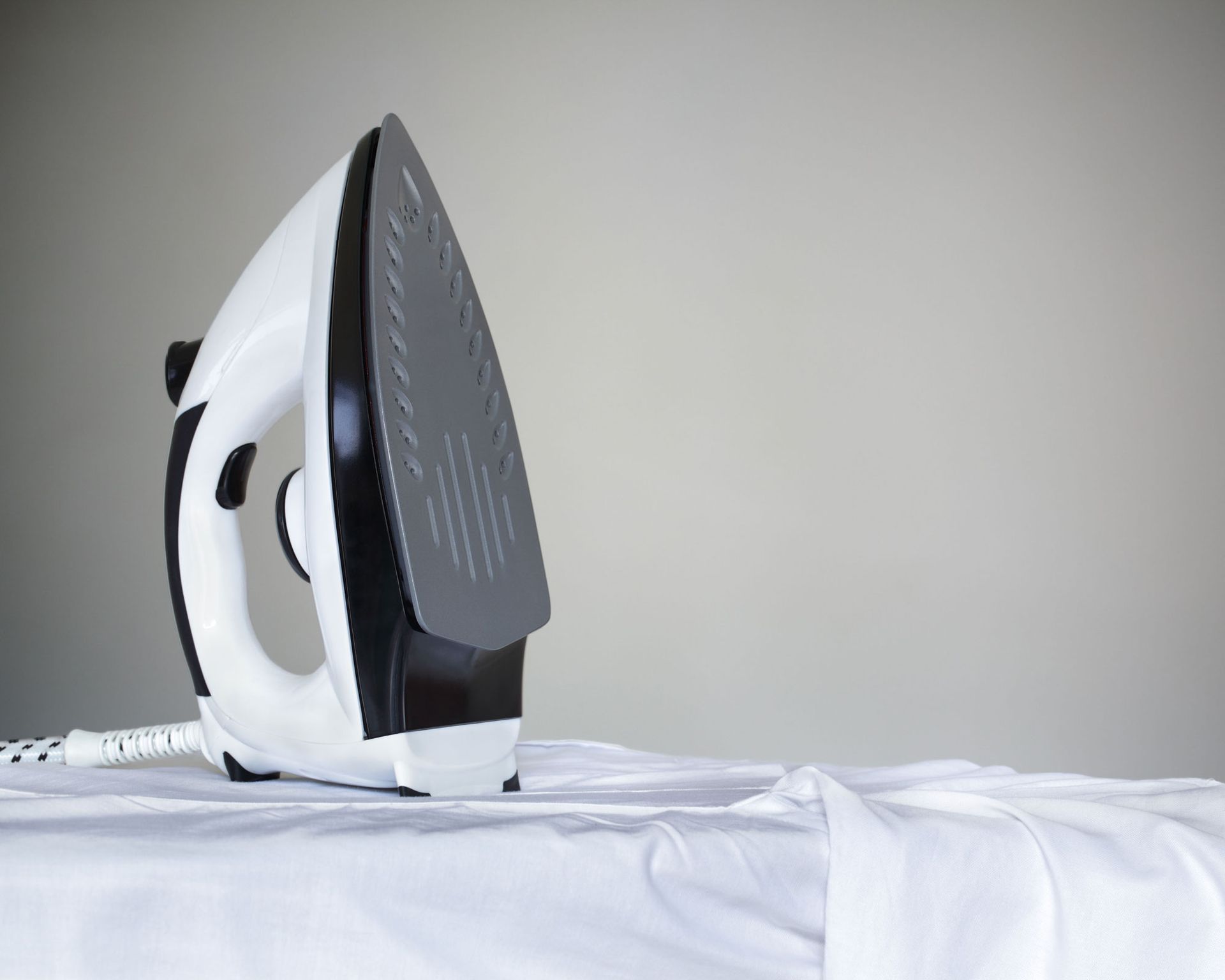 iron resting on ironing board