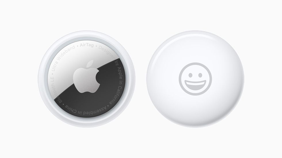 White Apple AirTag with a smiling emoji on it