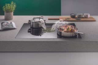 Hob with integrated cooker hood extraction