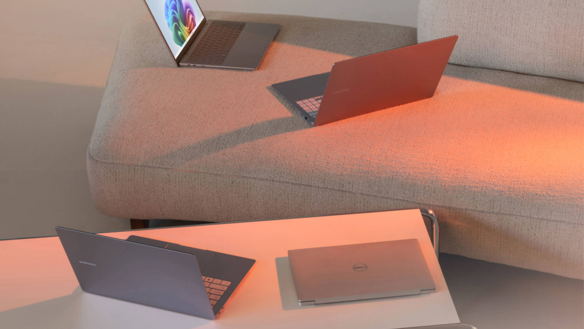 A promotional image showing several laptops resting on furniture, as part of Microsoft's Copilot+ AI PC ecosystem