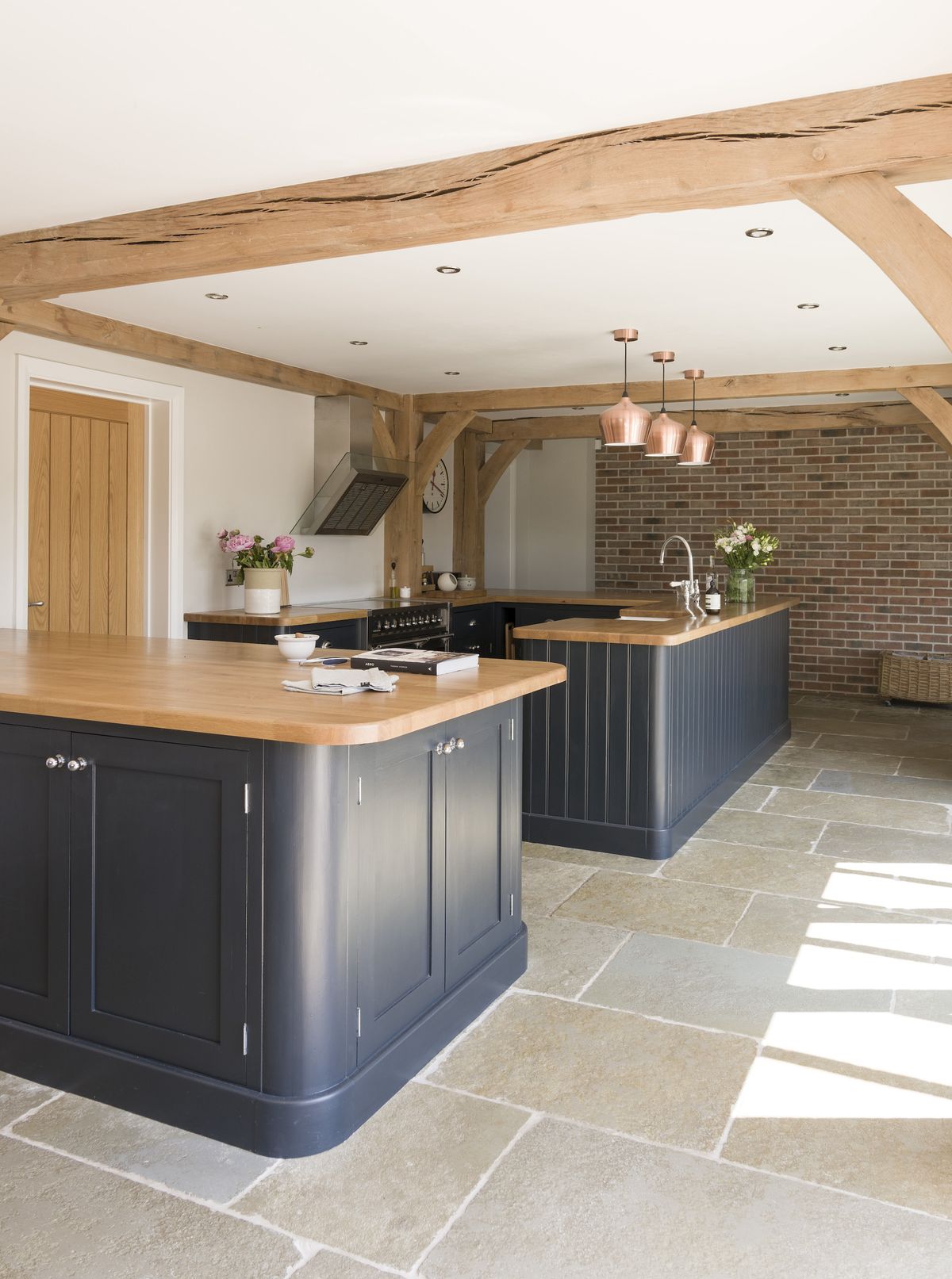 dark blue kitchen with wooden worktops
