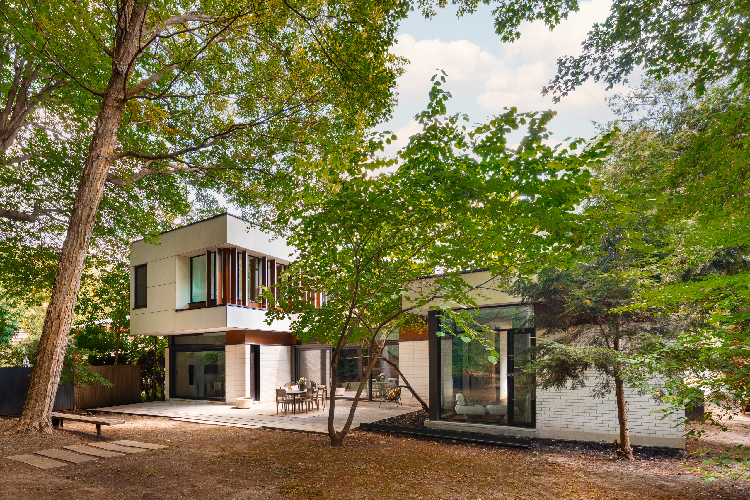 The house is integrated into the forest landscape