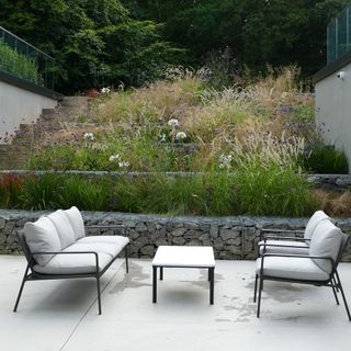 garden area with coffee table and cushions on seating bench