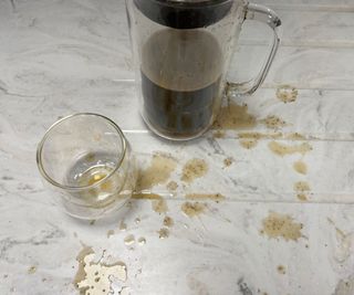 Zwilling Sorrento Plus French Press carafe and glass with coffee spilt on the countertop