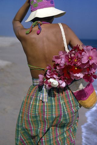 Woman in a crochet hat, bag, and swimsuit