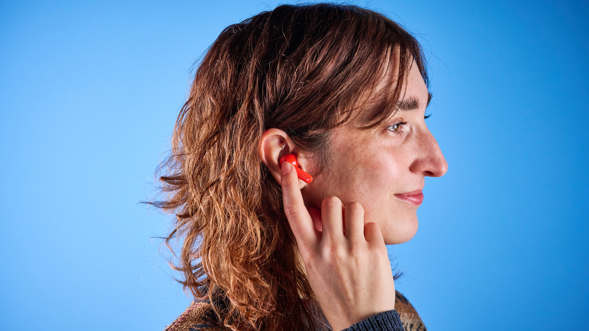 the nothing cmf buds pro 2 cmf by nothing buds pro 2 in bright orange shown in the smart dial charging case against a blue tom&#039;s guide background