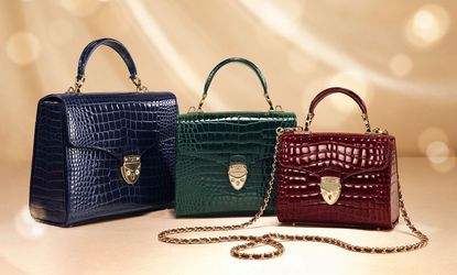 A trio of Aspinal bags in blue, green and red
