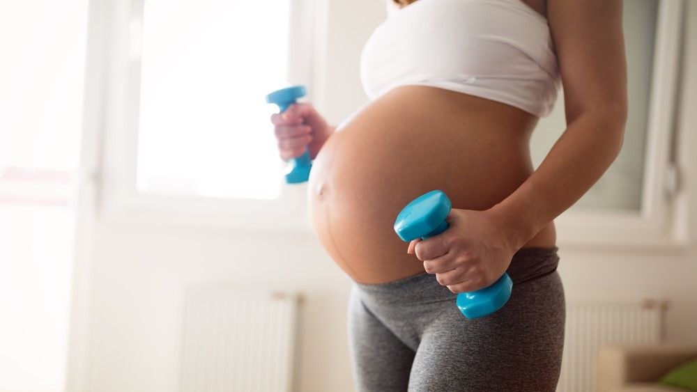 a photo of a woman doing exercise during pregnancy 