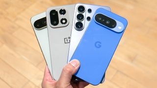 Google Pixel 10 Pro, OnePlus 15, Samsung Galaxy S26 Ultra and Google Pixel 10 held in a fan