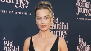 Margot Robbie in black and white corset dress with cutouts at the Big Bold Beautiful Journey premiere.