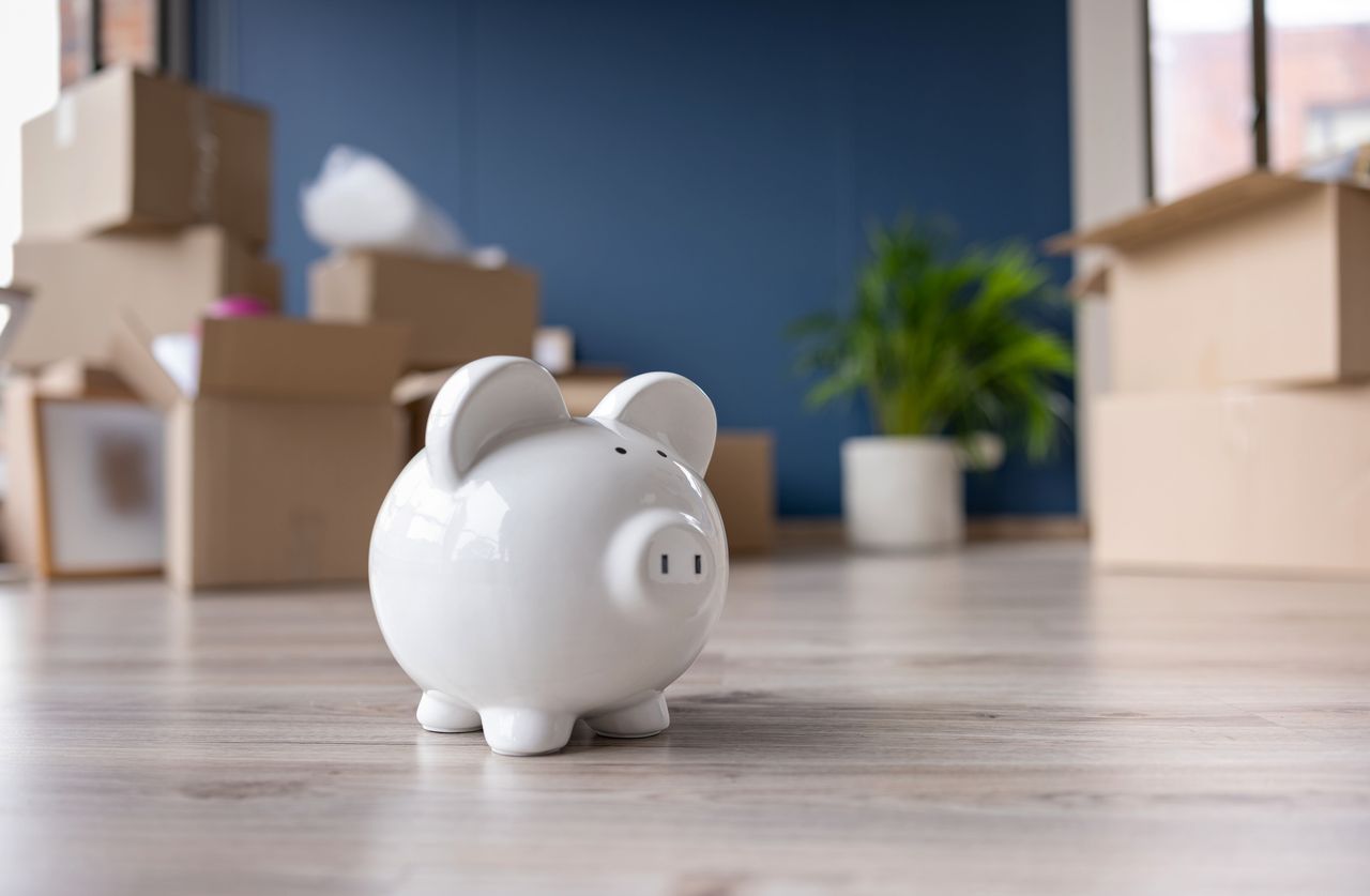 piggy bank in a home with moving boxes in the background