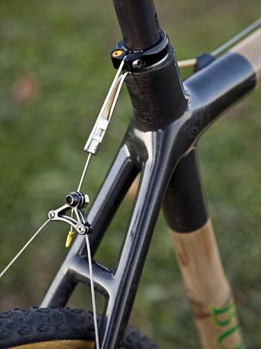 The rear brake housing stop is hung off of the seatpost collar instead of incorporated into the upper stays.