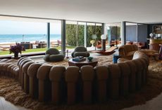 living room with ocean views and big brown sofa at Malibu beach house by Studio Shamshiri