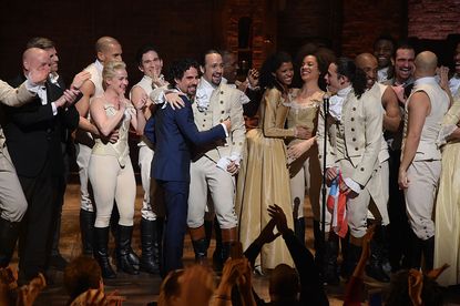 The cast of Hamilton celebrates.