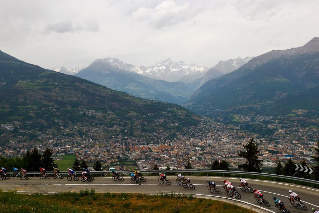 Riders cycle down towards Aosta Rear during the 15th stage of the Giro dItalia 2022 cycling race 177 kilometers from Rivarolo Canavese Piedmont to Cogne Aosta Valley on May 22 2022 Photo by Luca Bettini AFP Photo by LUCA BETTINIAFP via Getty Images