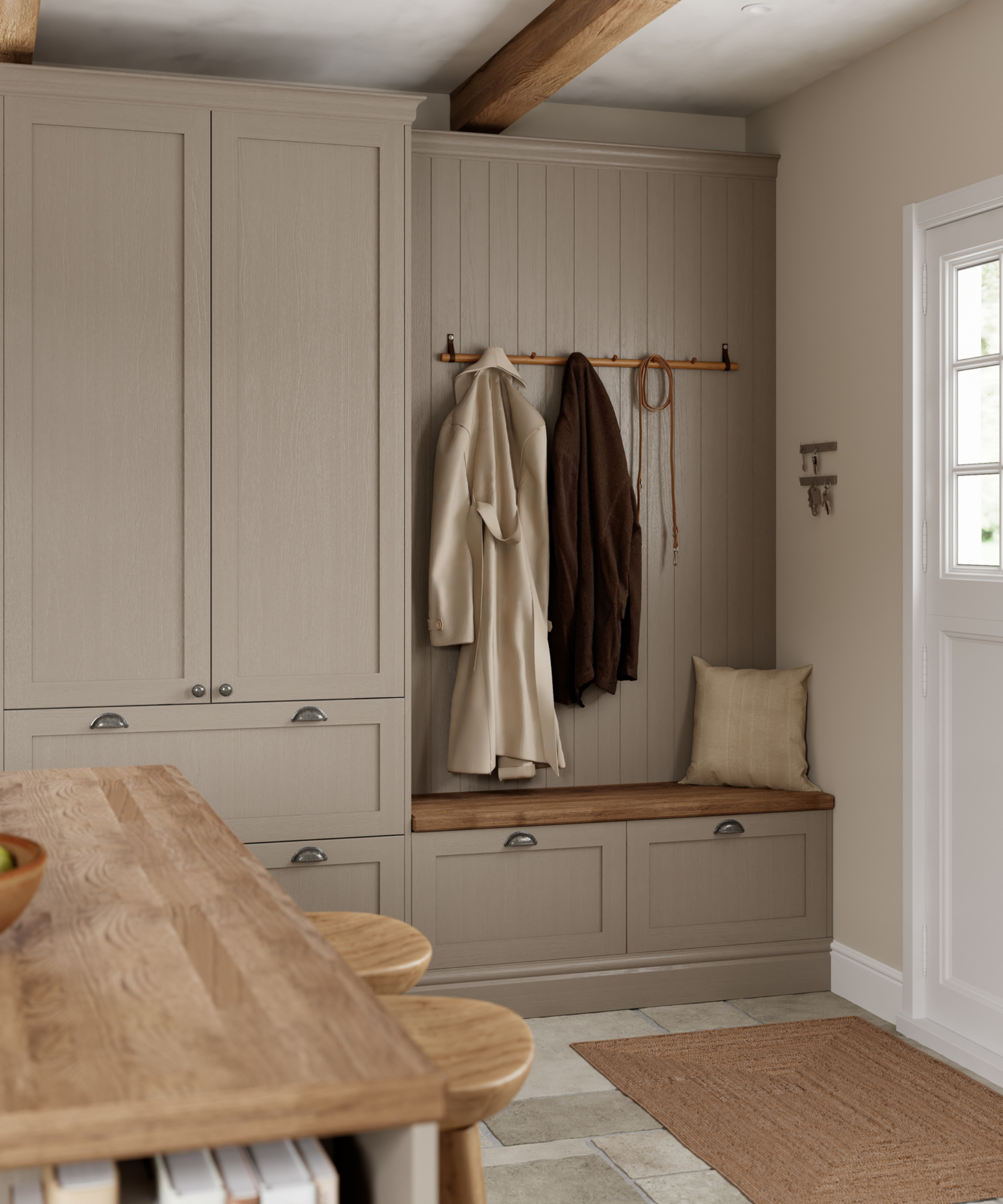 boot room area in kitchen painted in soft mushroom with seating area and hooks on panelled wall for coats
