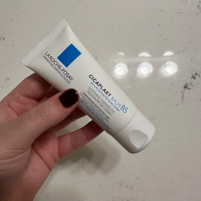 Kaitlyn McLintock holding a skincare product.