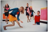 Four women posing wearing colorful clothing.