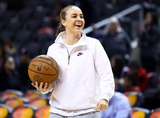 Assistant Coach Becky Hammon of the San Antonio Spurs smiles during warm up for an NBA game against the Toronto Raptors