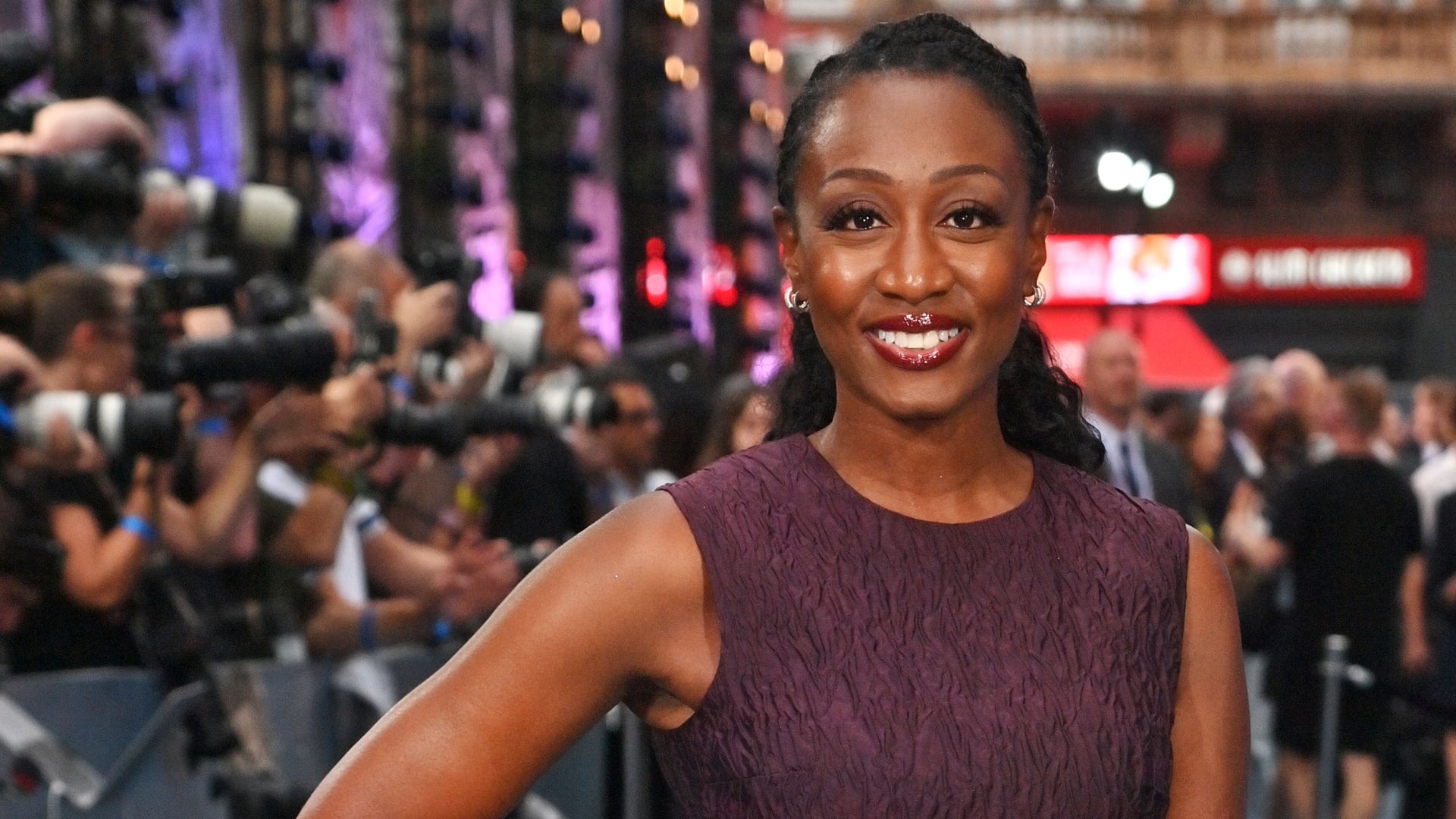 a headshot of beverley knight wearing a burgundy dress