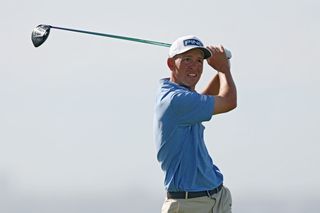 Sam Stevens watches his tee shot with a driver