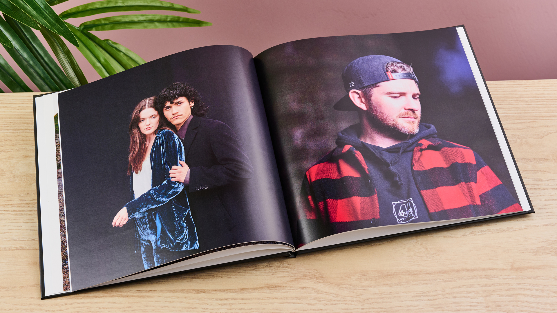 The Once Upon photo book sits open on a spread of two dark-colored portraits.