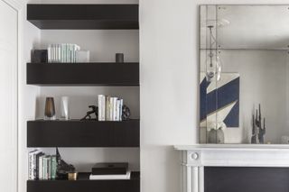 monochromatic living room, alcove shelving, black shelves