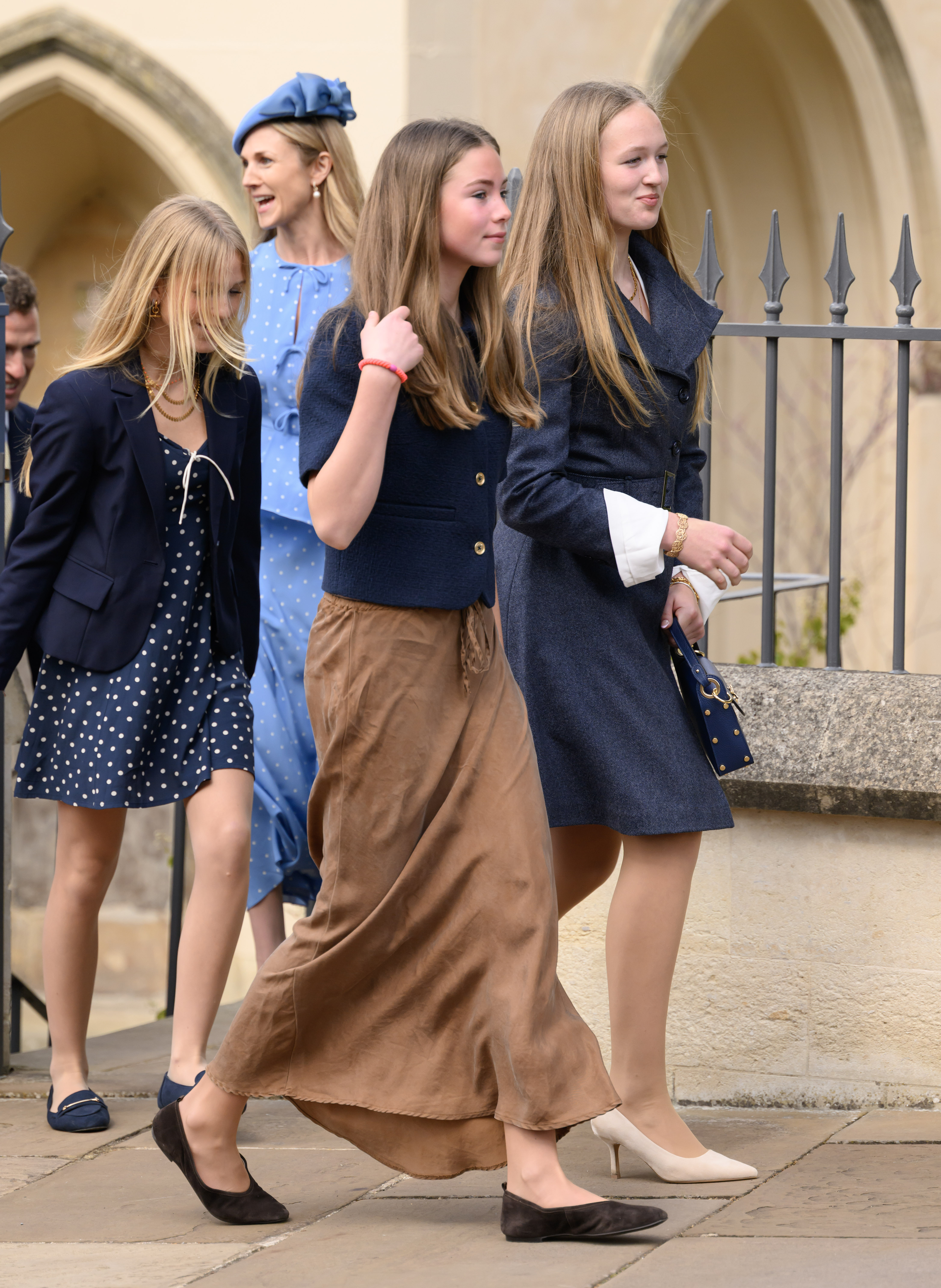 Isla Phillips, Harriet Sperling, Georgina Sperling and Savana Phillips walking outside St George's Chapel