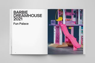 Barbie Dreamhouse book open at page with pink slide coming down from upper floor