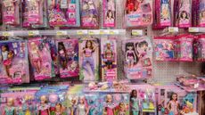 An aisle of dolls at a store