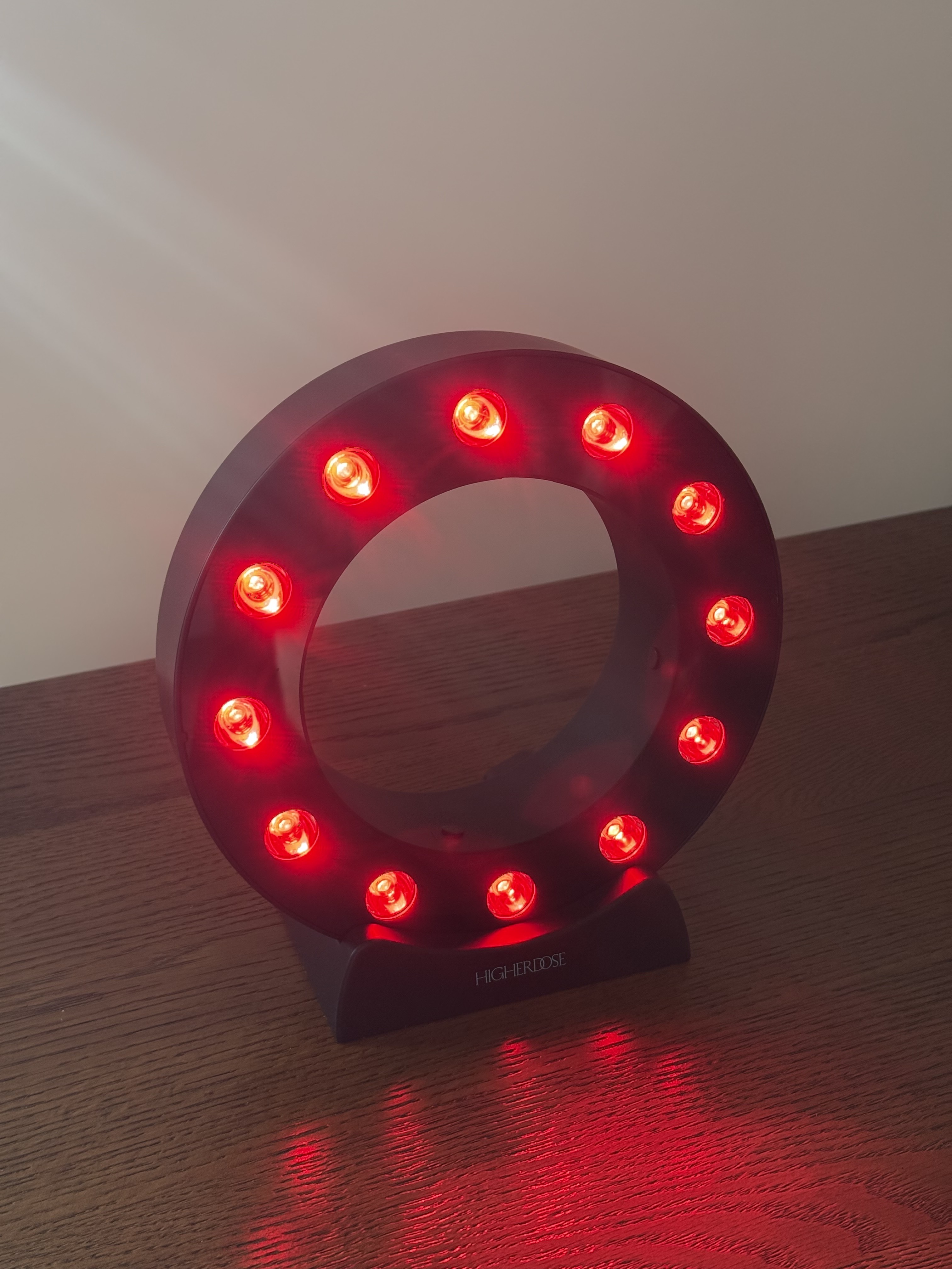 Photo of Jamie Schneider testing HigherDose's new Red Light Showerhead Filter