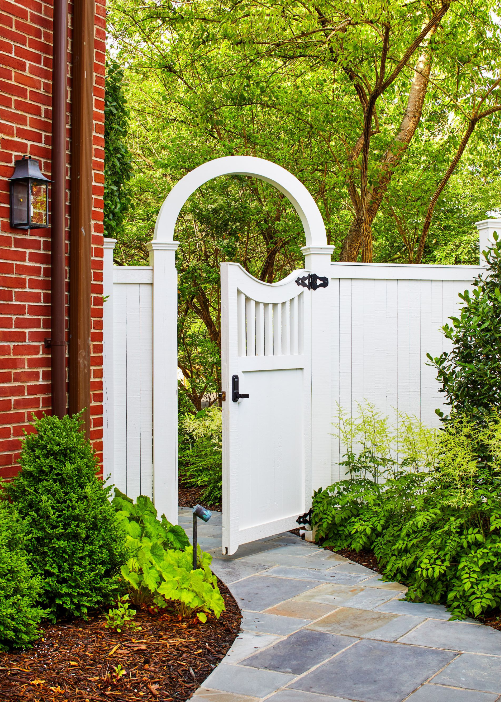 A tall fence with an entry door