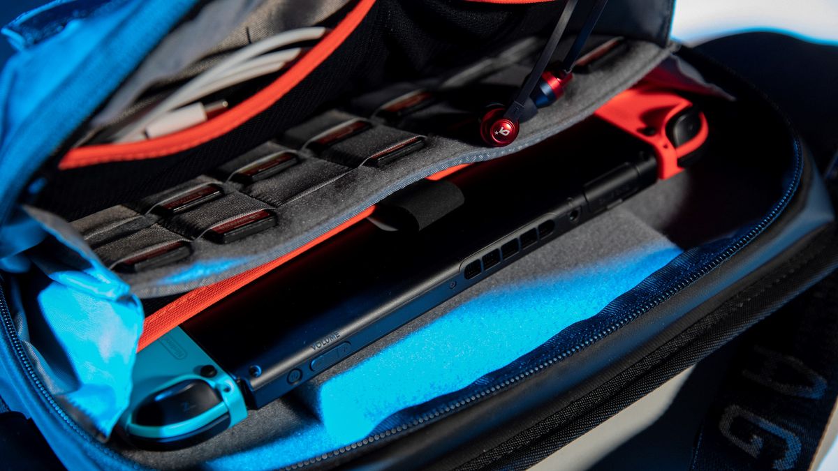 CS03 bag opened with Nintendo Switch and game cards in pockets.