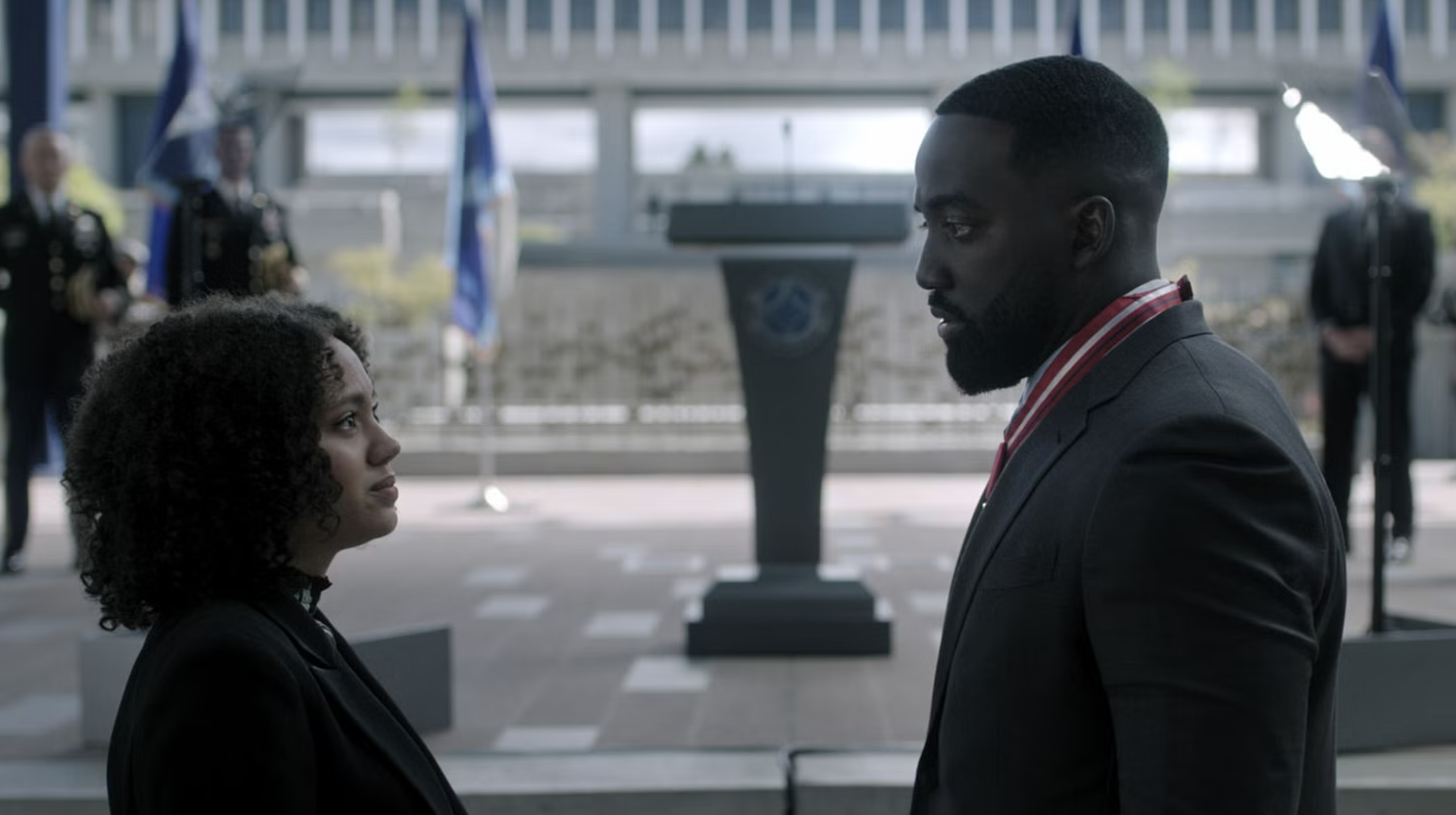 a woman and a man face off at a ceremony event