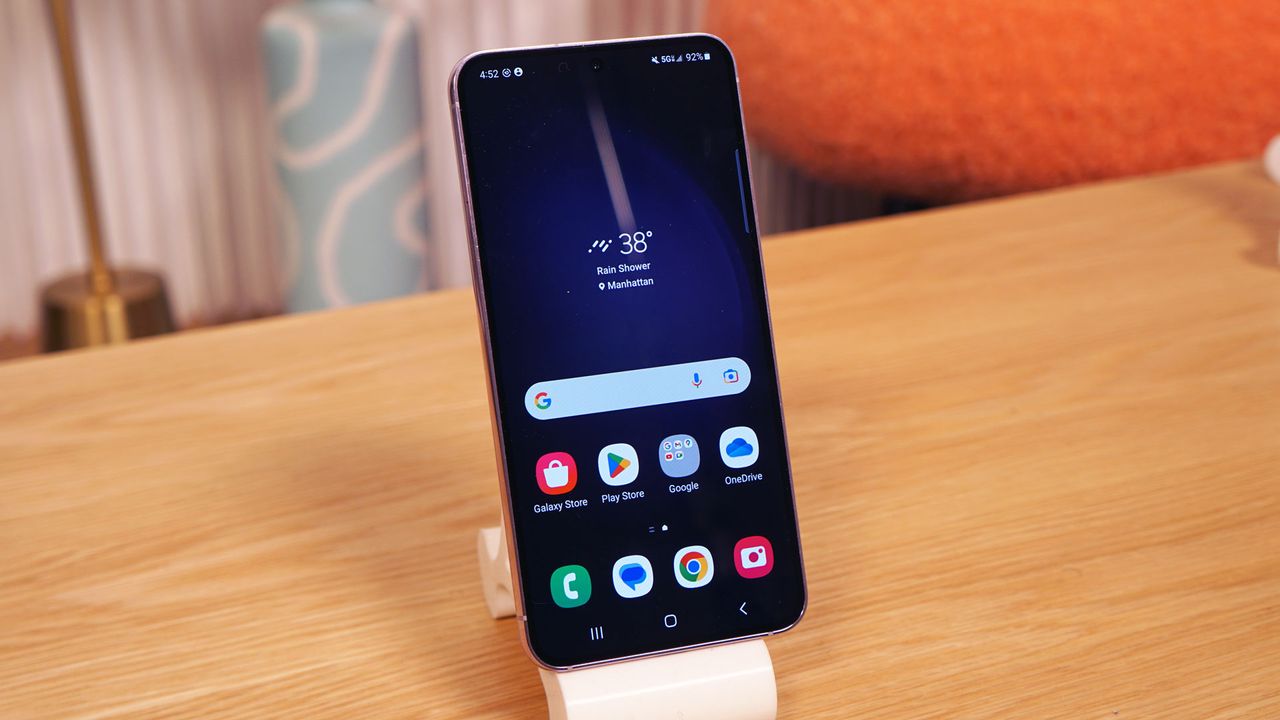 The Samsung Galaxy S23 Plus shown from the front. It's placed on a table with its home screen displayed