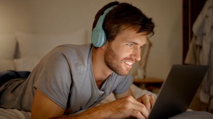 Man listening to music on his laptop