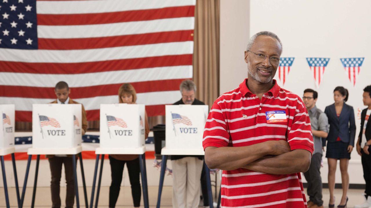 Retiree wearing an I Voted sticker at a polling place